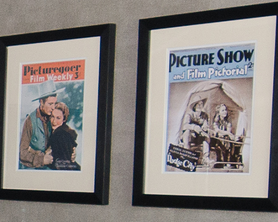 photos of films on the wall of cinema room