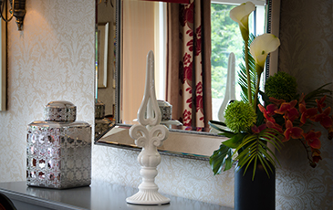 ornaments sat on table with a mirror behind