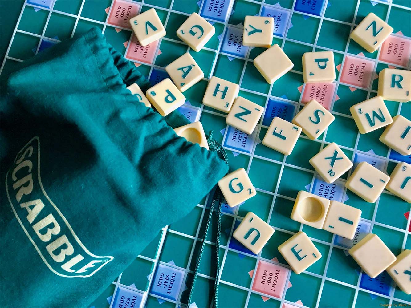 scrabble pieces spread across a board
